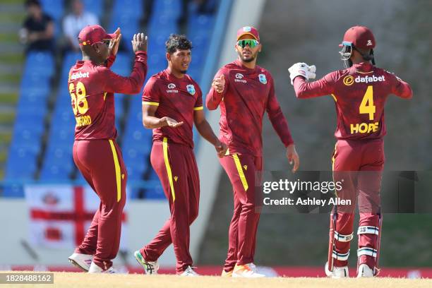 Gudakesh Motie of West Indies celebrates with teammates after getting the wicket of Phil Salt of England during the 1st CG United One Day...