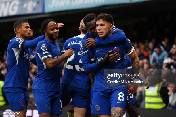 Enzo Fernandez of Chelsea celebrates with teammates after scoring the team's first goal during the Premier League match between Chelsea FC and...