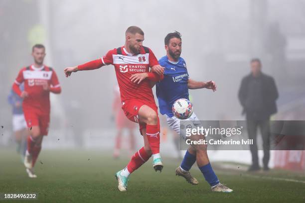 Will Grigg of Chesterfield is challenged by Brandon Cooper of Leyton Orient during the Emirates FA Cup Second Round match between Chesterfield and...
