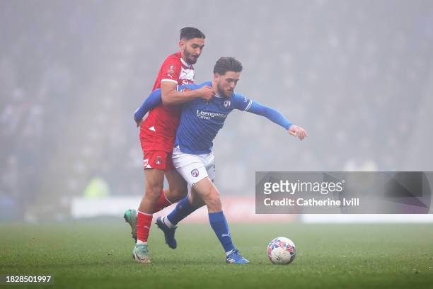 Darren Oldaker of Chesterfield is challenged by Idris El Mizouni of Leyton Orient during the Emirates FA Cup Second Round match between Chesterfield...