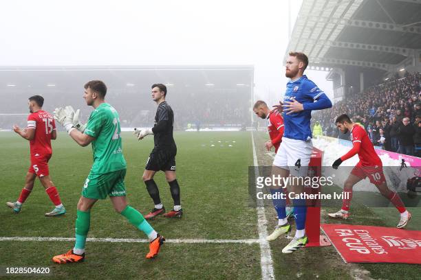 Players from Chesterfield and Leyton Orient are shown entering the pitch prior to the Emirates FA Cup Second Round match between Chesterfield and...
