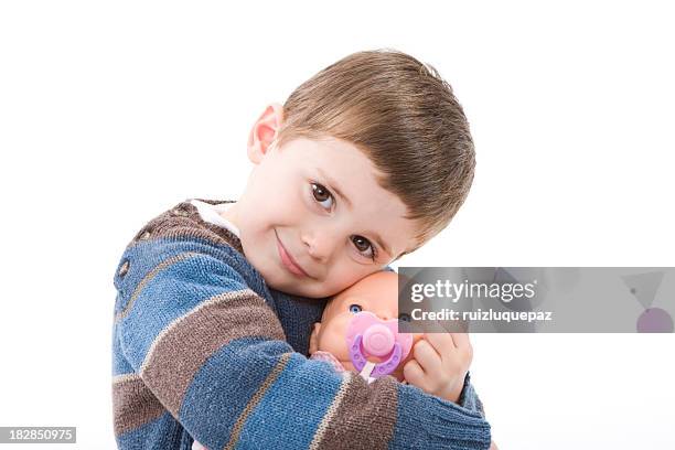 boy hugging a doll - doll stock pictures, royalty-free photos & images