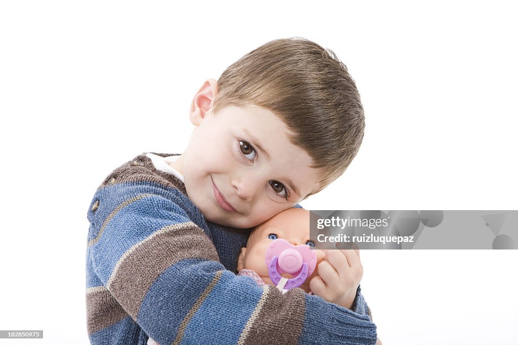 Boy hugging a doll