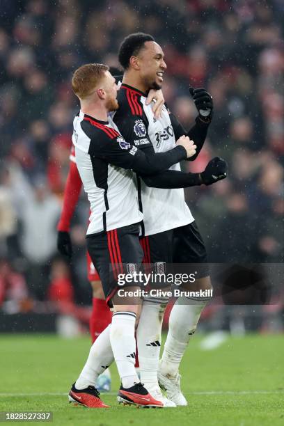 Kenny Tete of Fulham celebrates with teammate Harrison Reed after scoring the team's second goal during the Premier League match between Liverpool FC...