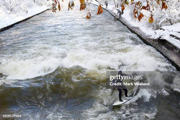 Surfer rides the Eisbach wave in the English Garden on December 3, 2023 in Munich, Germany. The Eisbach, wave is a man-made wave in the river that...