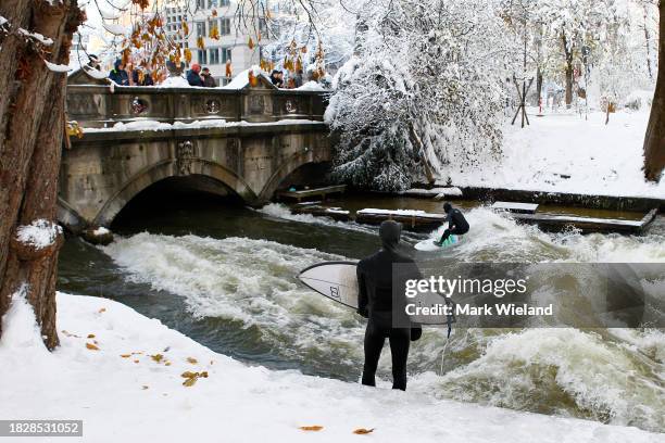 Surfer rides the Eisbach wave in the English Garden on December 3, 2023 in Munich, Germany. The Eisbach, wave is a man-made wave in the river that...