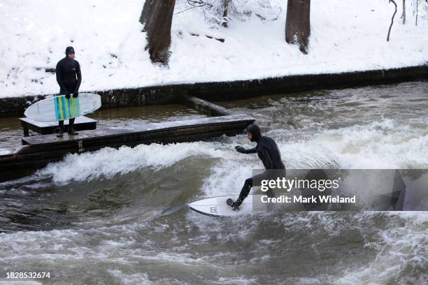 Surfer rides the Eisbach wave in the English Garden on December 3, 2023 in Munich, Germany. The Eisbach, wave is a man-made wave in the river that...