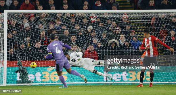Virgil van Dijk of Liverpool scores the 1st goal past Wes Foderingham, goalkeeper of Sheffield United during the Premier League match between...