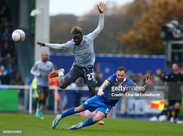 Chris Maguire of Eastleigh is challenged by Amadou Mbengue of Reading during the Emirates FA Cup Second Round match between Eastleigh and Reading at...