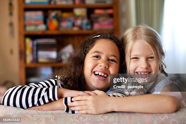 multiracial kids laughing indoors with pet kitten cat - cat laughing stock pictures, royalty-free photos & images