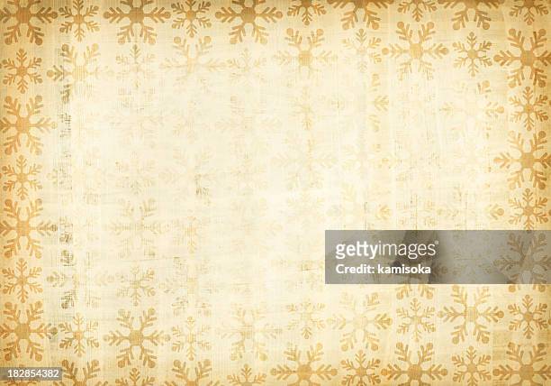 a grunge paper with patterns of snow flakes - christmas paper stockfoto's en -beelden