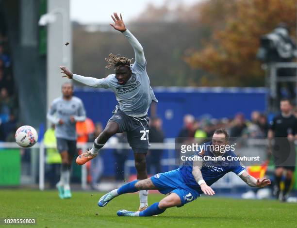 Amadou Mbengue of Reading is challenged by Chris Maguire of Eastleigh during the Emirates FA Cup Second Round match between Eastleigh and Reading at...