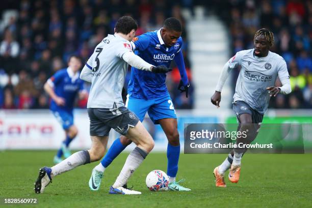 Jayden Harris of Eastleigh runs with the ball under pressure from Tom Holmes of Reading during the Emirates FA Cup Second Round match between...
