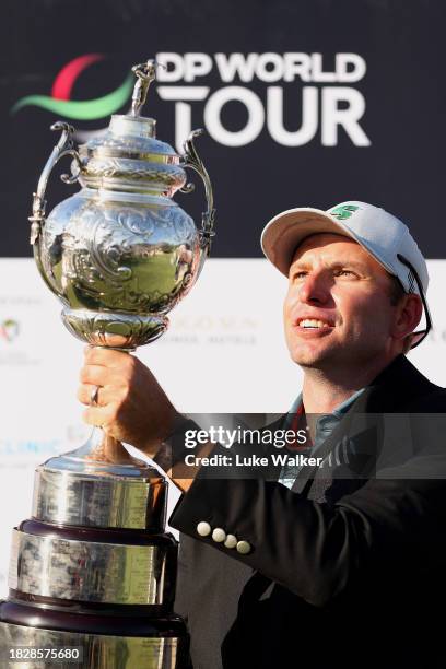 Dean Burmester of South Africa celebrates with the trophy after winning on the 18th green during day four of the Investec South African Open...