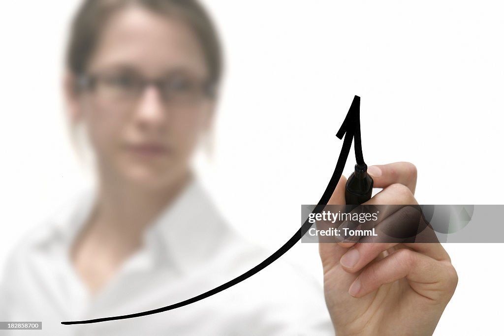 Businesswoman drawing graph