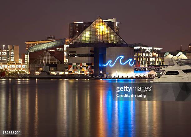 baltimore's inner harbor and national aquarium lit at night - baltimore maryland stock pictures, royalty-free photos & images