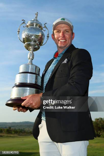 Dean Burmester of South Africa celebrates with the trophy after winning during day four of the Investec South African Open Championship at Blair...