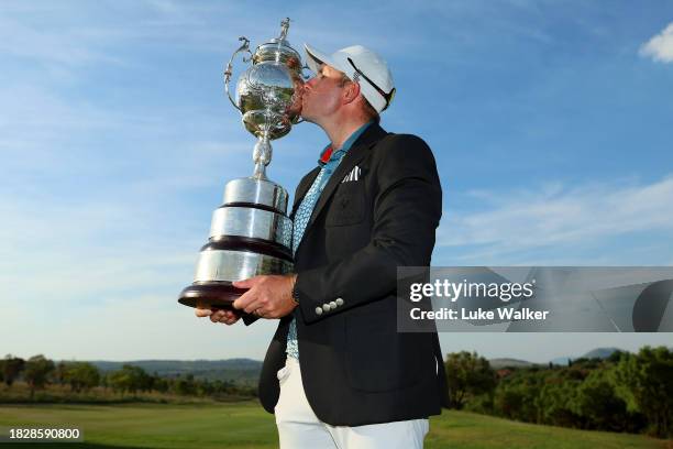 Dean Burmester of South Africa celebrates with the trophy after winning during day four of the Investec South African Open Championship at Blair...