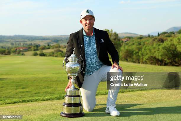 Dean Burmester of South Africa celebrates with the trophy after winning during day four of the Investec South African Open Championship at Blair...