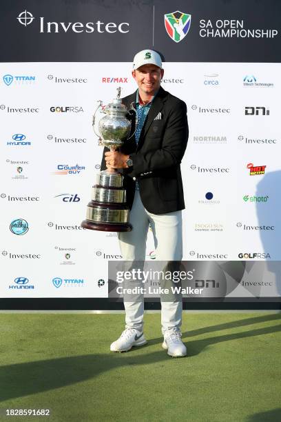 Dean Burmester of South Africa celebrates with the trophy after winning during day four of the Investec South African Open Championship at Blair...