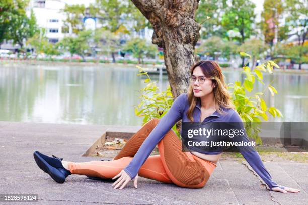 thai transgender doing   yoga stretching and looking away - kathoey stock pictures, royalty-free photos & images