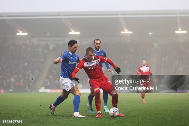 Joe Pigott of Leyton Orient is challenged by Ash Palmer and Oliver Banks of Chesterfield during the Emirates FA Cup Second Round match between...