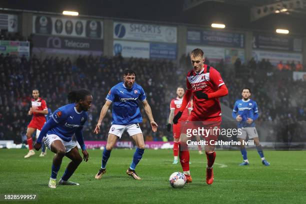 Joe Pigott of Leyton Orient runs with the ball under pressure from Jeff King of Chesterfield during the Emirates FA Cup Second Round match between...