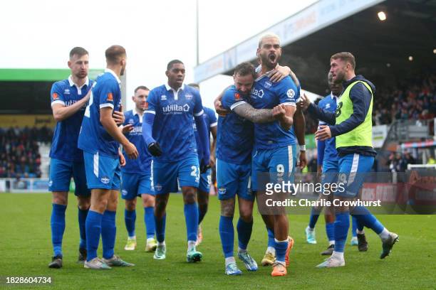 Paul McCallum of Eastleigh celebrates with teammates after scoring the team's second goal during the Emirates FA Cup Second Round match between...