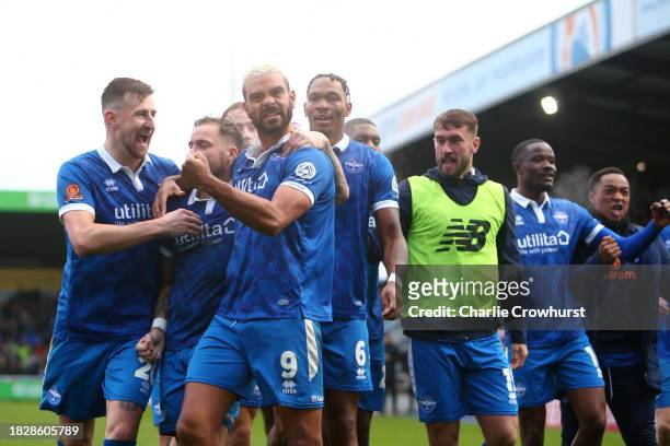 Paul McCallum of Eastleigh celebrates with teammates after scoring the team's second goal during the Emirates FA Cup Second Round match between...