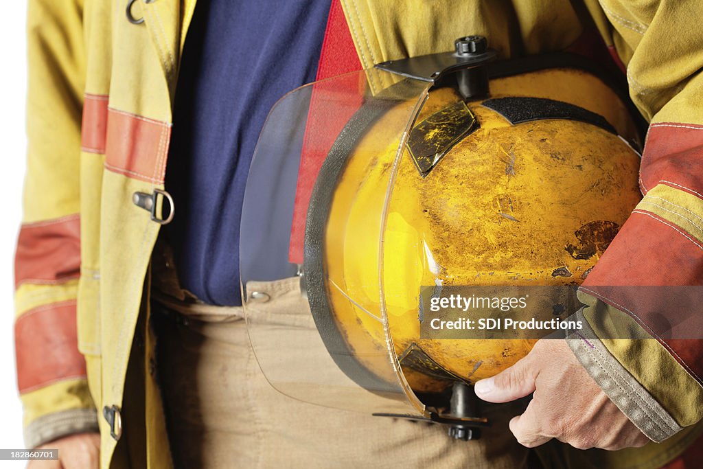 Closeup of Helmet Held By Firefighter