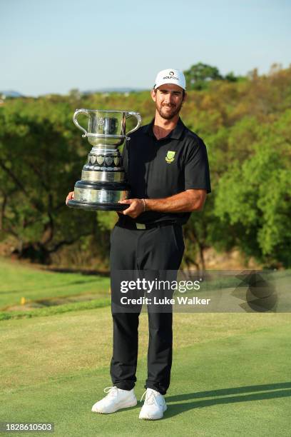 Altin Van Der Merwe of South Africa poses with the trophy for the Leading Amateur during day four of the Investec South African Open Championship at...