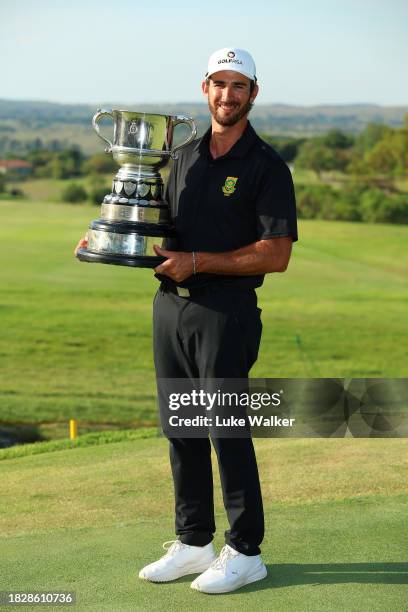 Altin Van Der Merwe of South Africa poses with the trophy for the Leading Amateur during day four of the Investec South African Open Championship at...