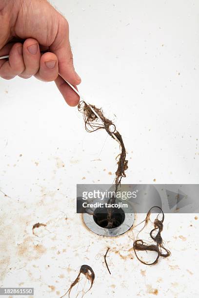 pulling hair from a drain - plug hole stock pictures, royalty-free photos & images