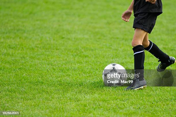 kid playing soccer - kicking football stock pictures, royalty-free photos & images