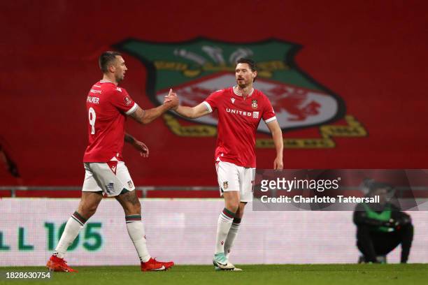 Ollie Palmer of Wrexham celebrates with teammate George Evans of Wrexham after scoring the team's first goal during the Emirates FA Cup Second Round...