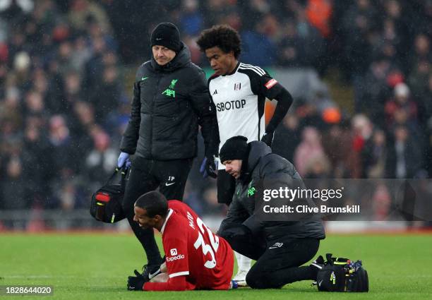 Joel Matip of Liverpool receives medical treatment during the Premier League match between Liverpool FC and Fulham FC at Anfield on December 03, 2023...