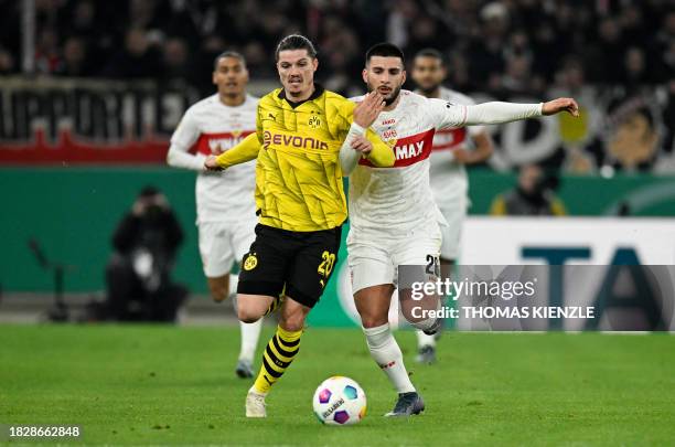 Dortmund's Austrian midfielder Marcel Sabitzer and Stuttgart's German forward Deniz Undav vie for the ball during the German Cup round of 16 football...