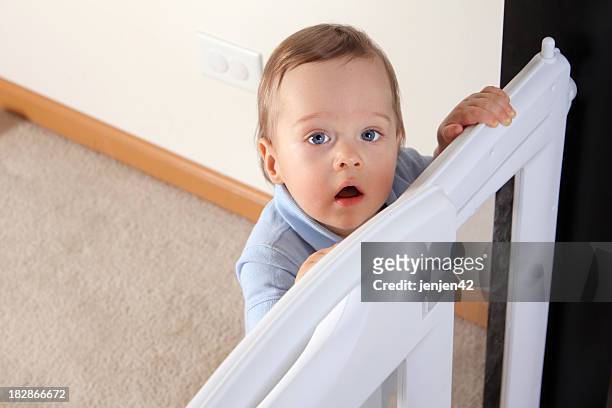 happy child at baby gate - child proofing stock pictures, royalty-free photos & images