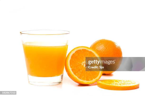 oranges and glass of juice - orange juice stock pictures, royalty-free photos & images