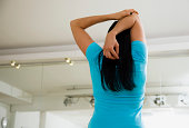Rear View of Woman Doing Triceps Stretch