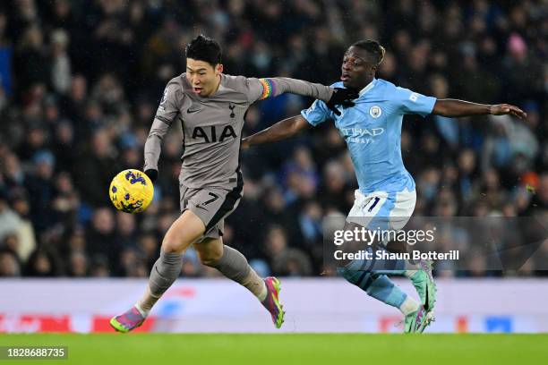 Son Heung-Min of Tottenham Hotspur is challenged by Jeremy Doku of Manchester City during the Premier League match between Manchester City and...