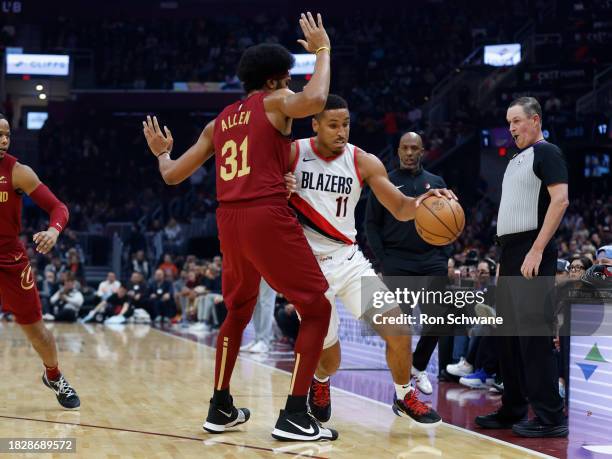 Malcolm Brogdon of the Portland Trail Blazers drives against Jarrett Allen of the Cleveland Cavaliers during the first half at Rocket Mortgage...