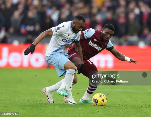 Jordan Ayew of Crystal Palace is tacked by Mohammed Kudus of West Ham United of West Ham United during the Premier League match between West Ham...
