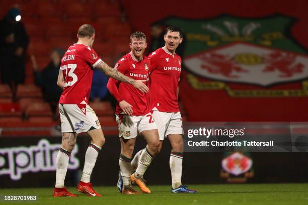 Andy Cannon of Wrexham celebrates with teammates James McClean and Thomas O'Connor after scoring the team's second goal during the Emirates FA Cup...