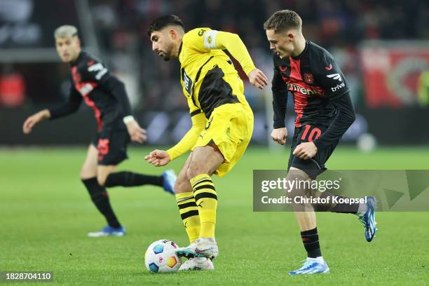 Emre Can of Borussia Dortmund controls the ball whilst under pressure from Florian Wirtz of Bayer Leverkusen during the Bundesliga match between...