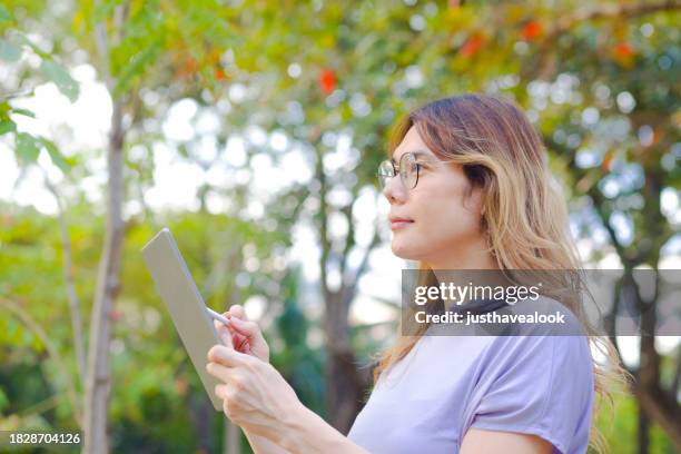headshot  of thai transgender standing and sketching in park - kathoey stock pictures, royalty-free photos & images