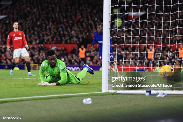 Manchester United goalkeeper Andre Onana looks back at the ball in the net after Cole Palmer of Chelsea scores against him during the Premier League...