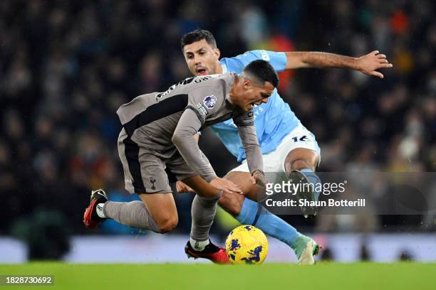 Pedro Porro of Tottenham Hotspur is tackled by Rodri of Manchester City during the Premier League match between Manchester City and Tottenham Hotspur...