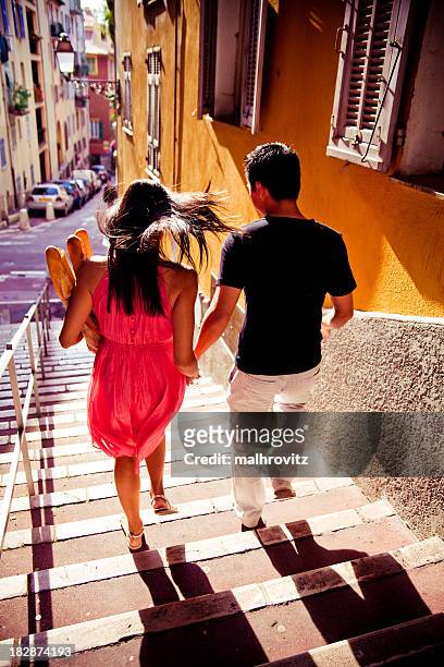 lovers escaping with baguetts - nice france stock pictures, royalty-free photos & images