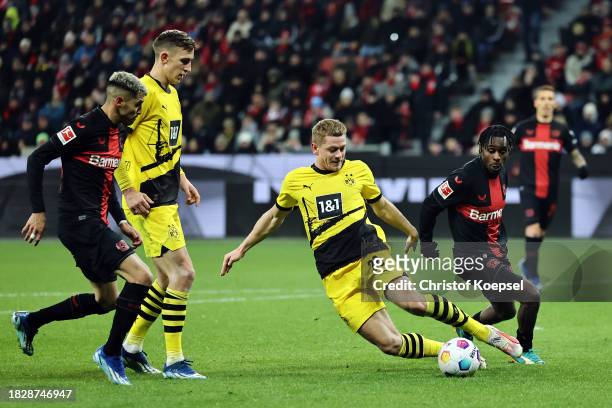 Julian Ryerson of Borussia Dortmund controls the ball whilst under pressure during the Bundesliga match between Bayer 04 Leverkusen and Borussia...